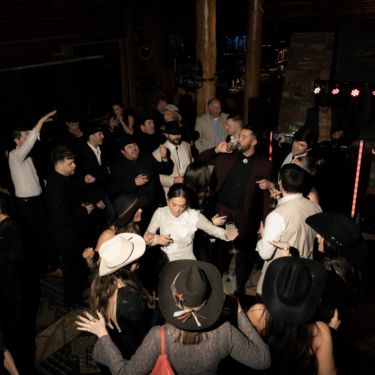 Packed dance floor, hats in the air