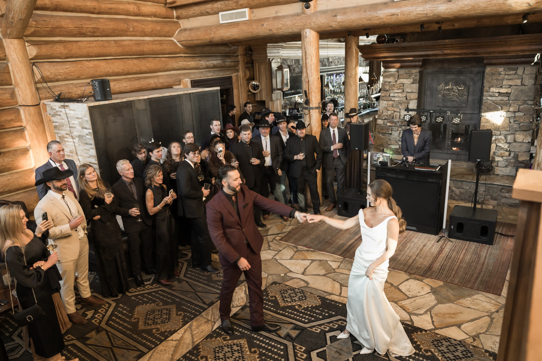 First dance, guests circled, DJ booth lit